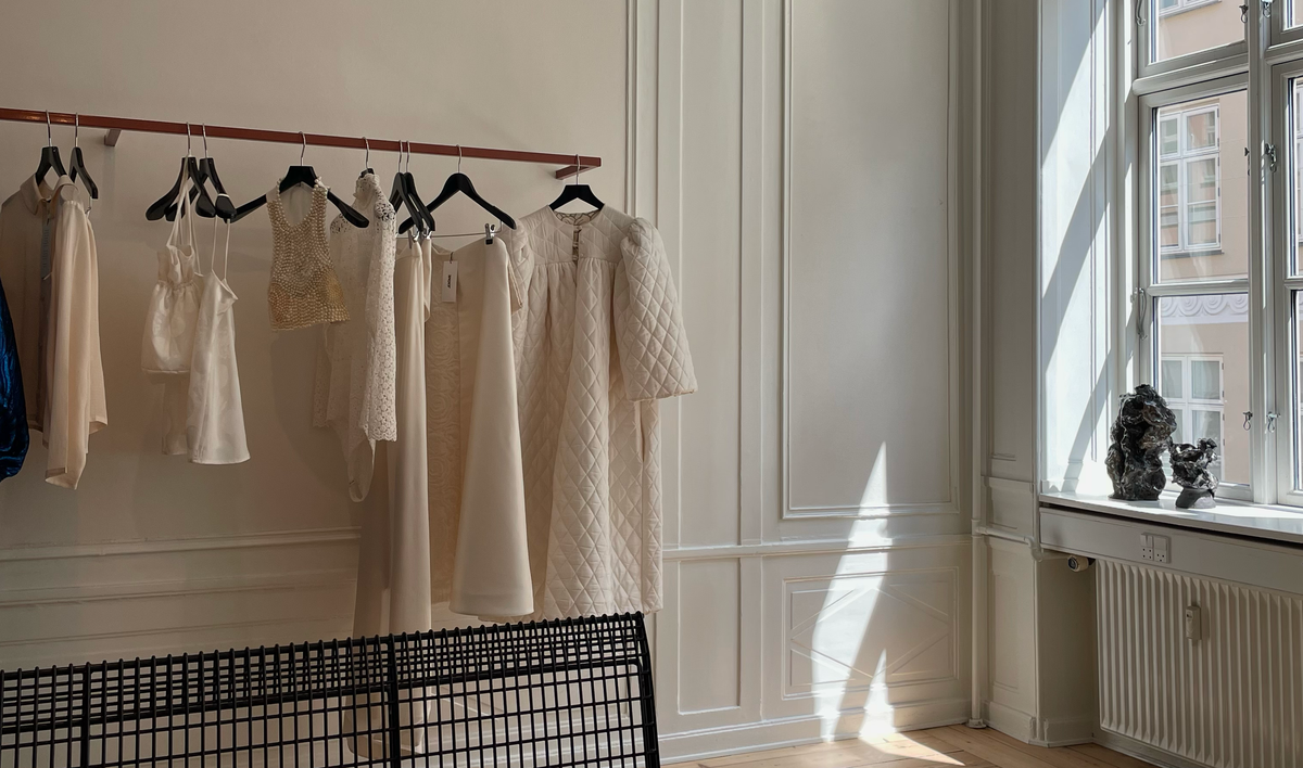 A perfect day itinerary in Copenhagen showcasing elegant clothing displays in a bright room.