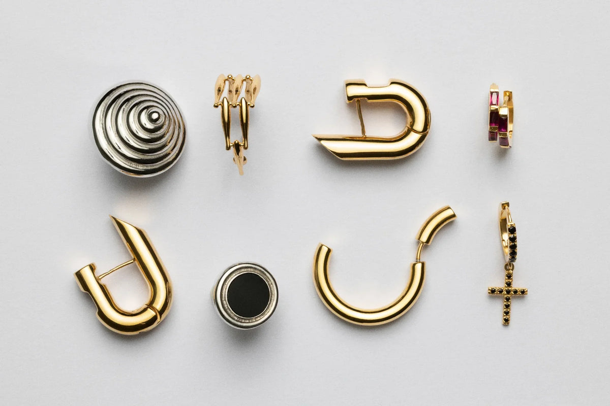 various unique earrings displayed, showcasing 925 silver and 18ct gold in archive jewelry design return