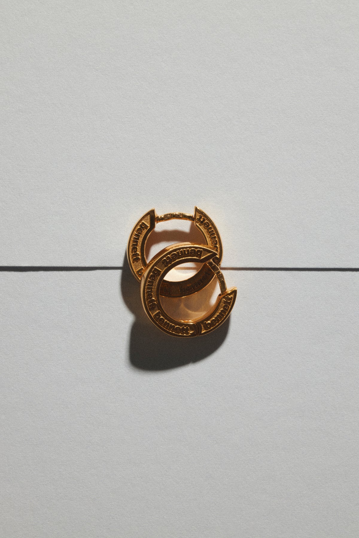 personalized engraved earrings featuring a unique design, handmade and nickel-free, displayed on a neutral background.