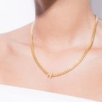 model wearing alphabet necklace with pendant N in gold