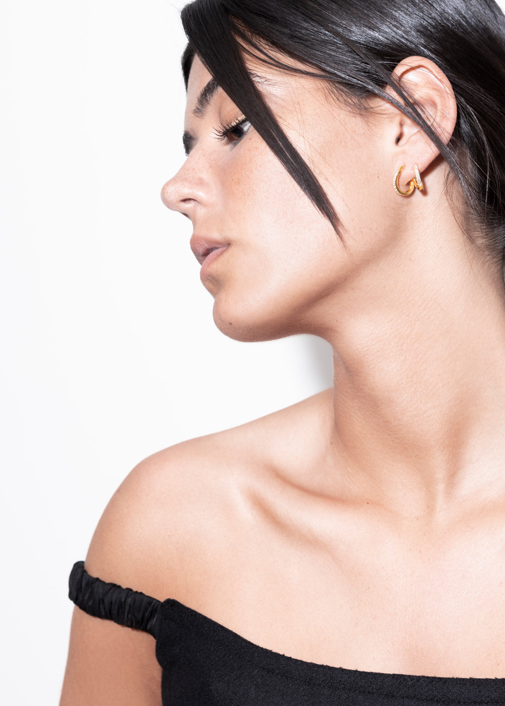 model wearing amina double layer earrings in gold