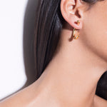 model wearing cat earrings in gold