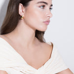 model wearing constantin earrings in gold