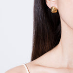 model wearing diana earrings in gold