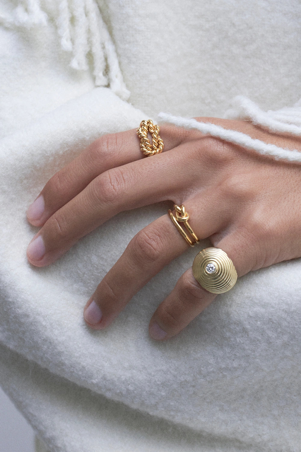 model wearing multiple gold rings 