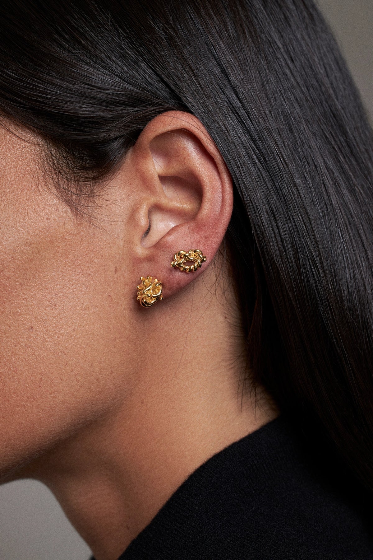 CINCO golden-stud-earrings-worn-on-ear-unique-design-detail