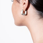 model wearing magda huggies in silver