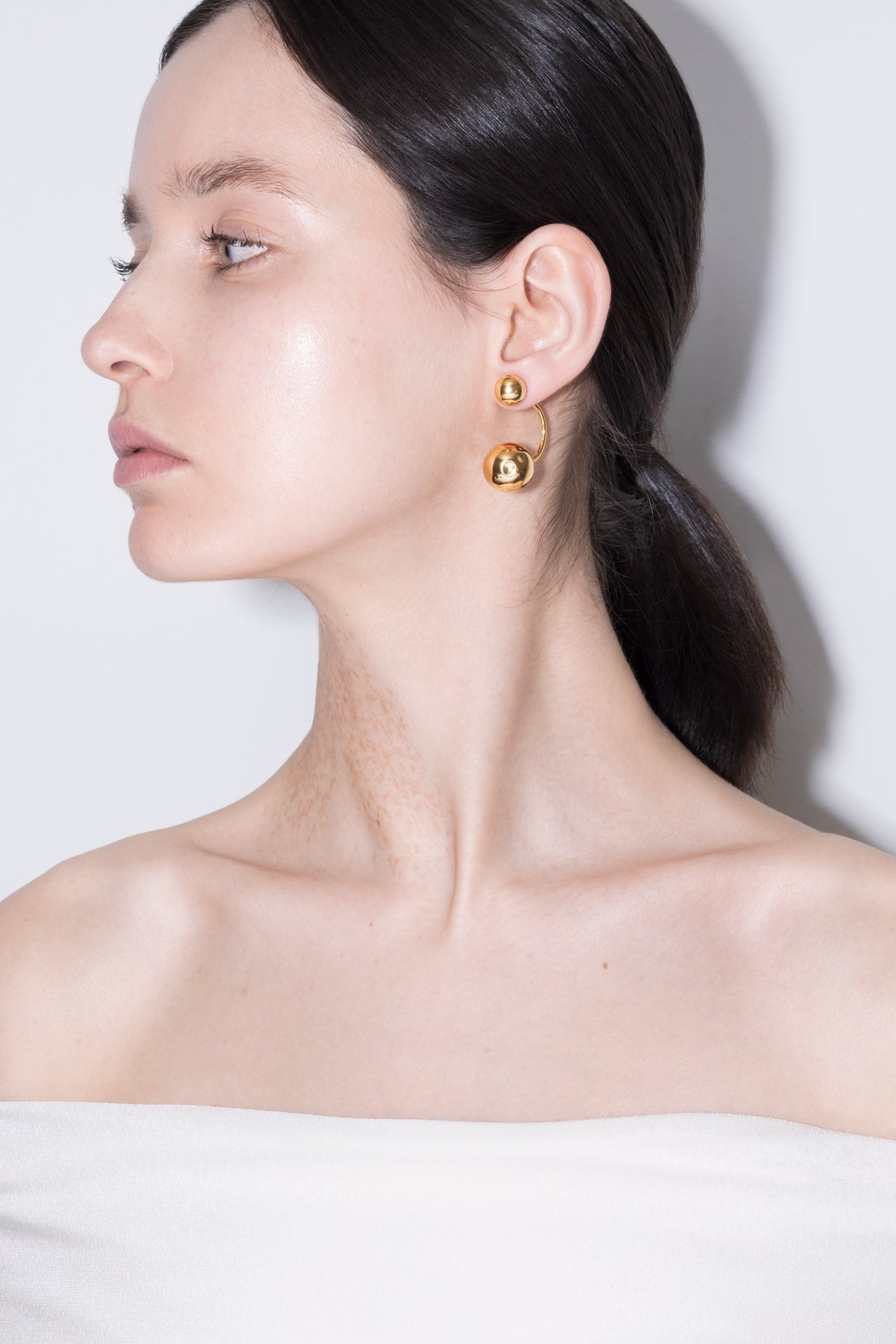 model wearing pamela earrings in gold