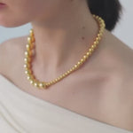 video of model wearing jackie necklace in gold