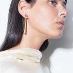 model wearing sade earrings in gold